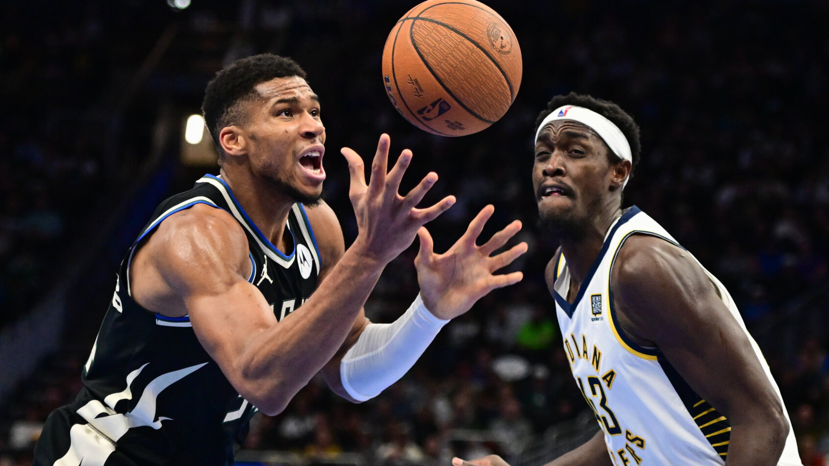Milwaukee Bucks forward Giannis Antetokounmpo battles for a loose ball against and Indiana Pacers forward Pascal Siakam