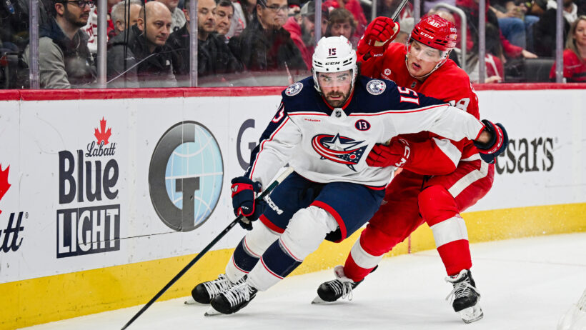 Dante Fabbro fends off a Red Wings attacker.
