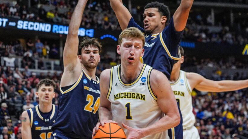Michigan Wolverines forward Danny Wolf holds the ball under the basket against the UC San Diego Tritons