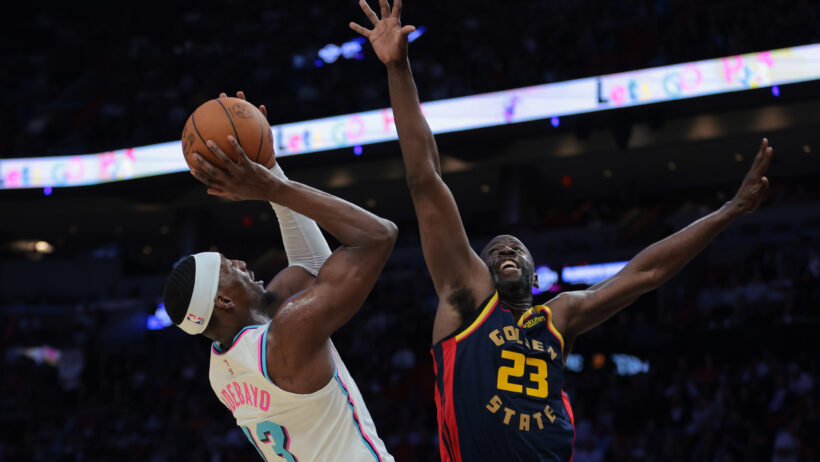 Draymond Green tries to block a Bam Adebayo shot.
