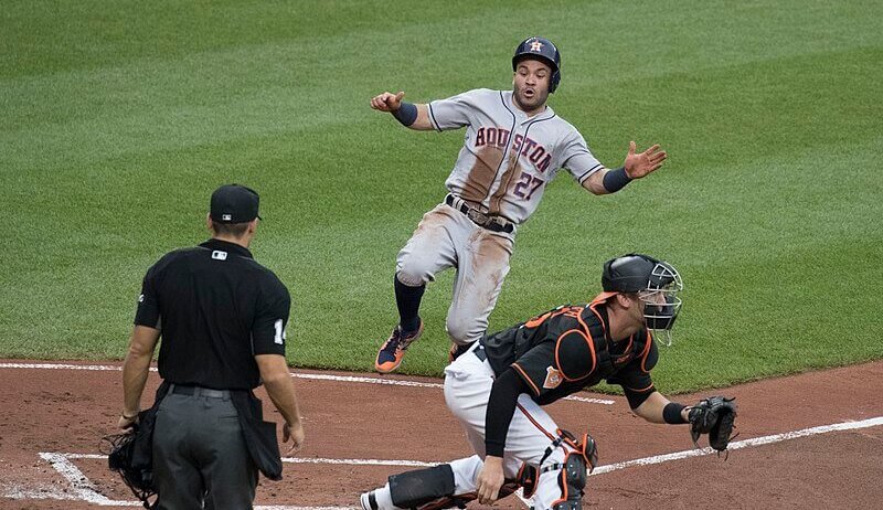 Jose ALtuve of the Houston Astros sliding into home
