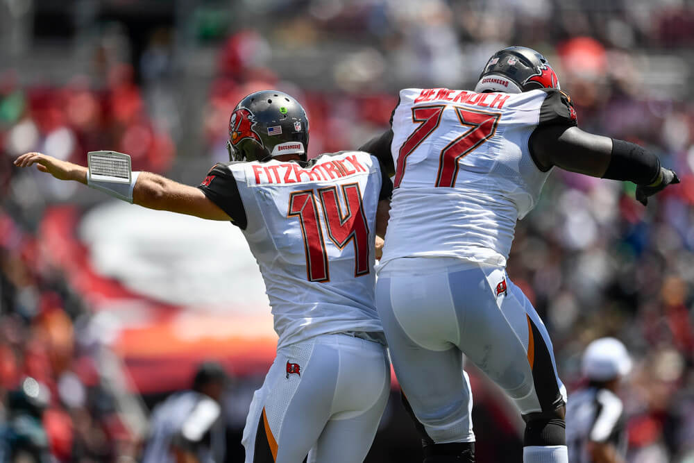Ryan Fitzpatrick and Caleb Benenoch of the Tampa Bay Buccaneers celebrate a touchdown