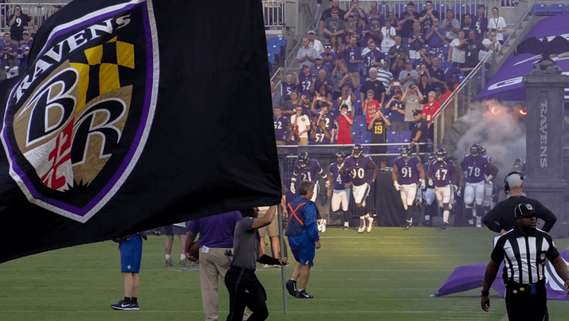 A Baltimore Ravens flag flying on the field pregame.