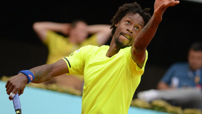 Monfils throws up a serve.