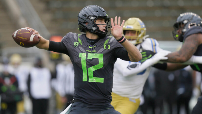 Oregon's quarterback Tyler Shough throwing a football downfield during a game.