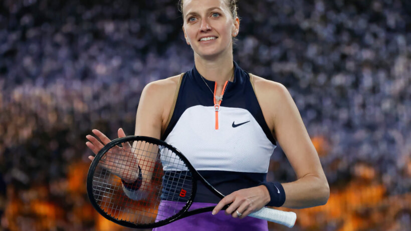 Petra Kvitova celebrating by clapping her racket after a tennis match win.