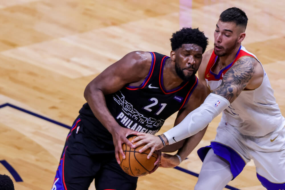Joel Embiid going to basket with defender on him