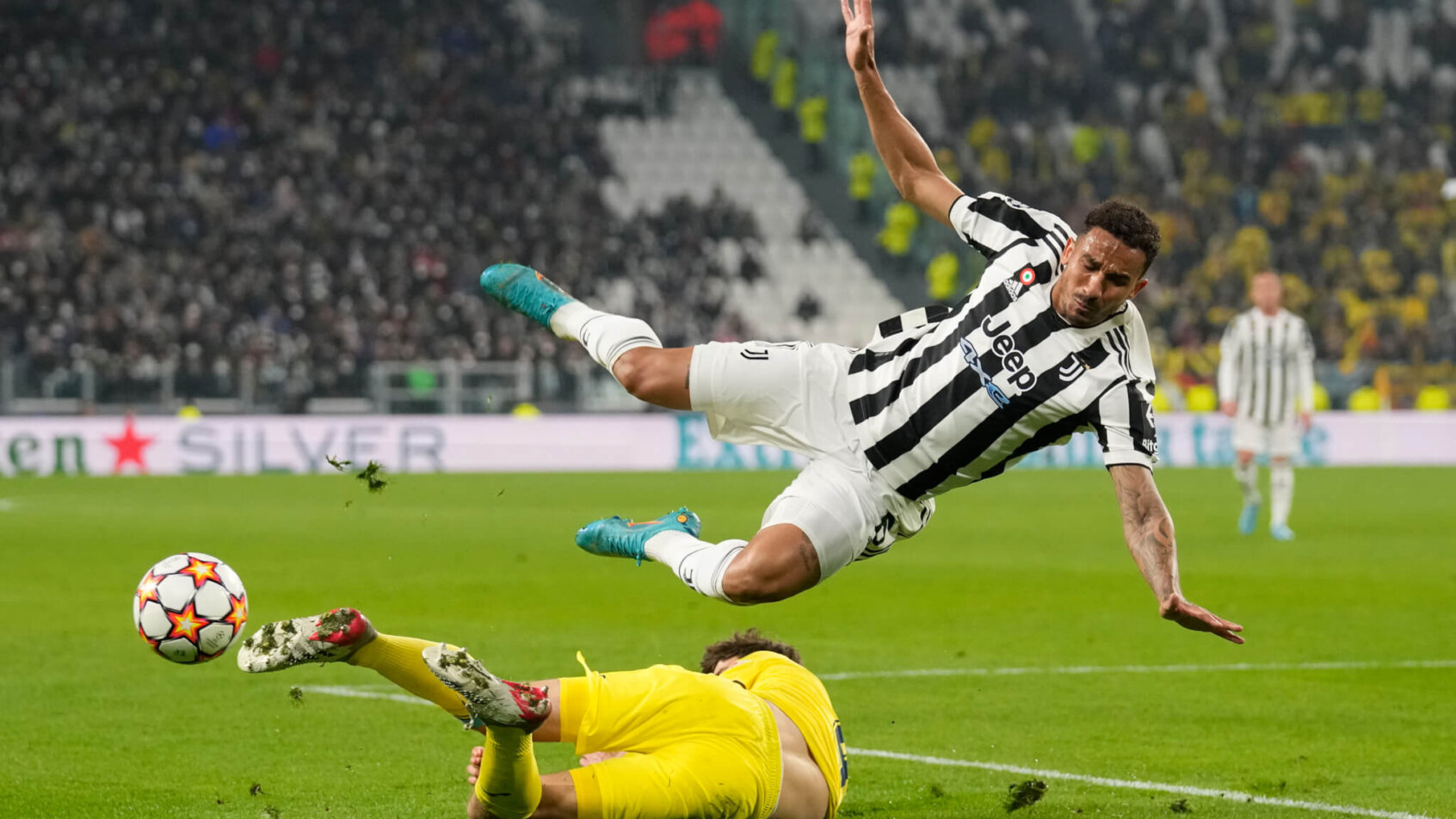 Juventus' Danilo getting tackled by Villarreal's Pau Torres during the Champions League round of 16 soccer match.
