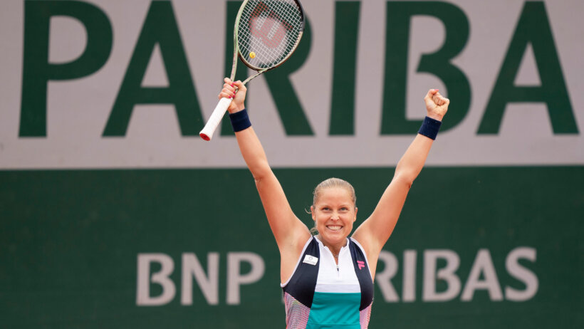 Shelby Rogers celebrating with her arms up in the air after a win.