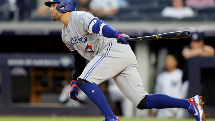 Toronto Blue Jays designated hitter George Springer hits a run-scoring single