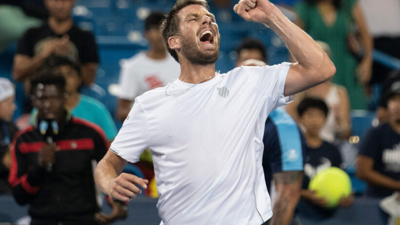 Cameron Norrie celebrating with a fist pump after a win.