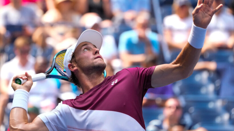 Casper Ruud serving a ball during a tennis match at the US Open.