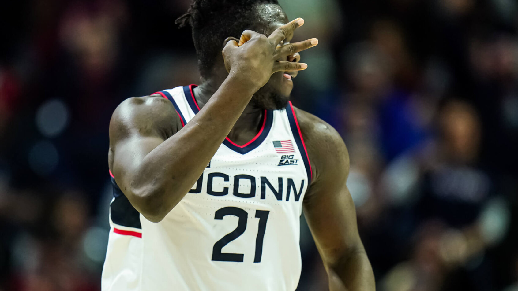 UConn Huskies forward Adama Sanogo gestures after hitting a three