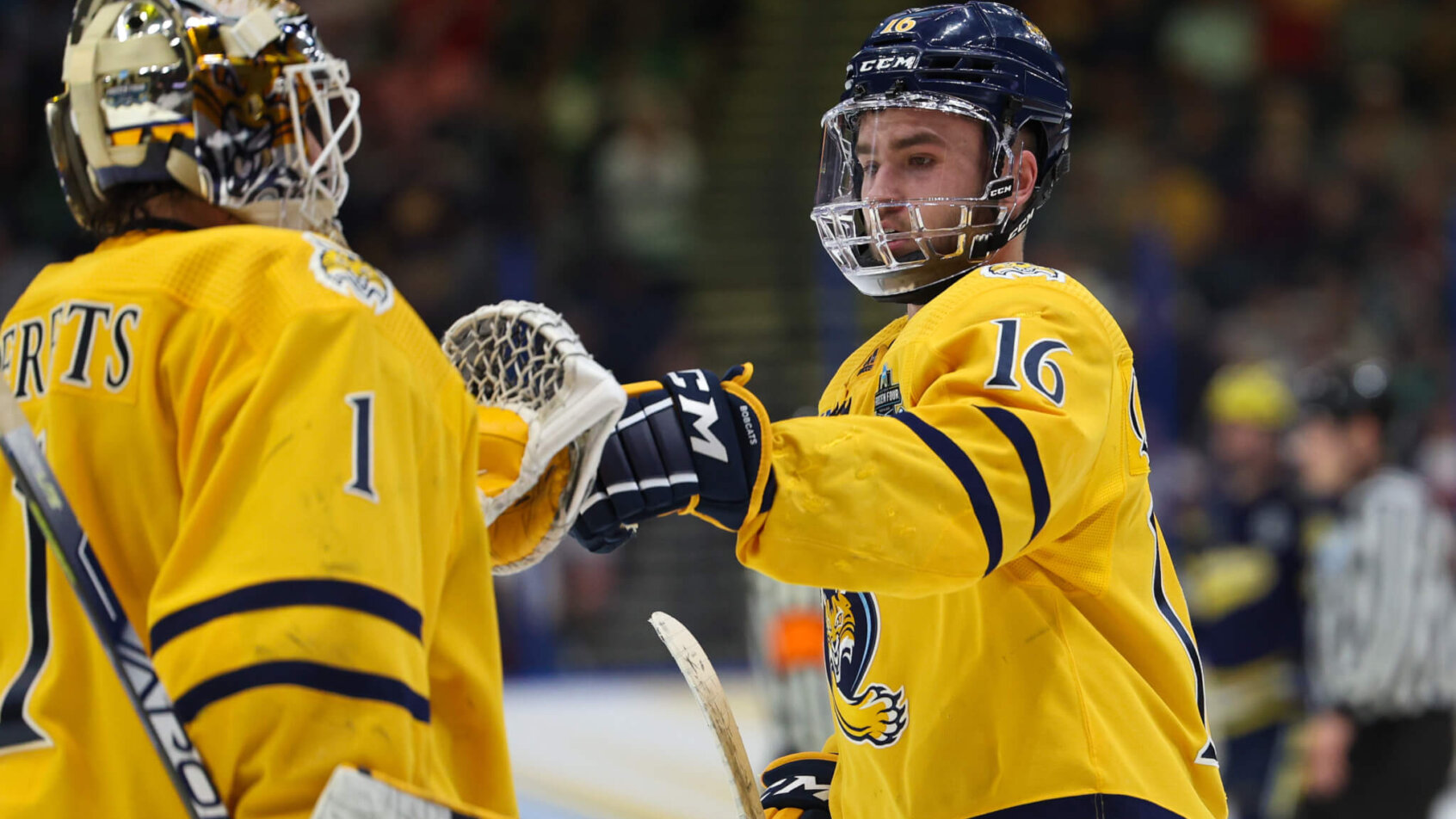 Quinnipiac forward Jacob Quillan and goaltender Yaniv Perets celebrate