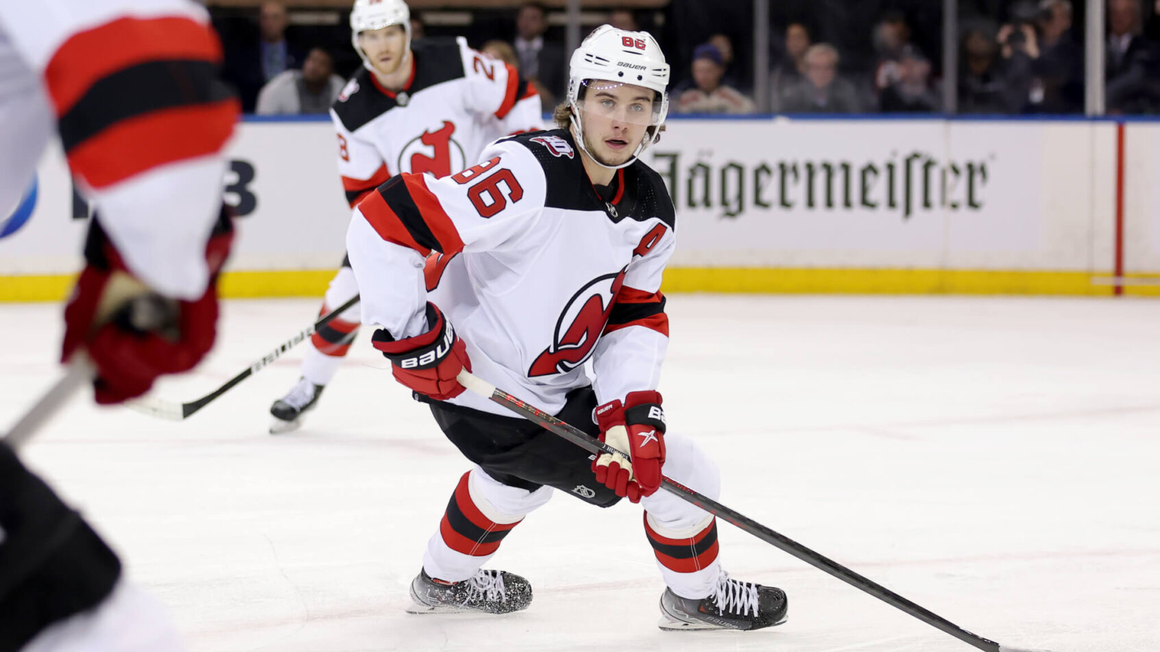 New Jersey Devils center Jack Hughes controls the puck against the New York Rangers
