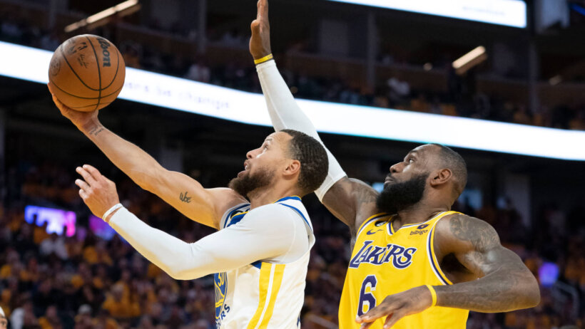 LeBron James tries to block Steph Curry's layup