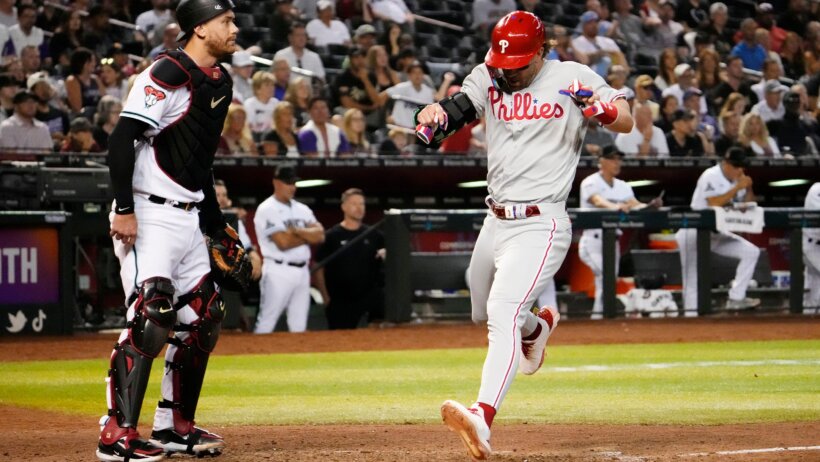 Philadelphia Phillies designated hitter Bryce Harper scoring a run against the Arizona Diamondbacks