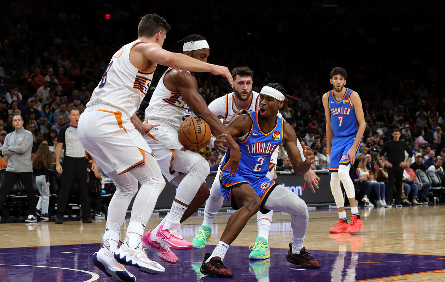 Phoenix Suns forward Keita Bates-Diop strips the ball away from Oklahoma City Thunder guard Shai Gilgeous-Alexander