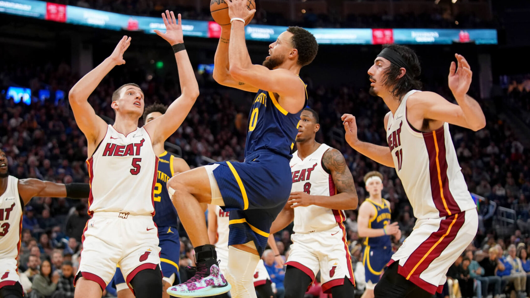 Golden State Warriors guard Stephen Curry shooting a floater against the Miami Heat