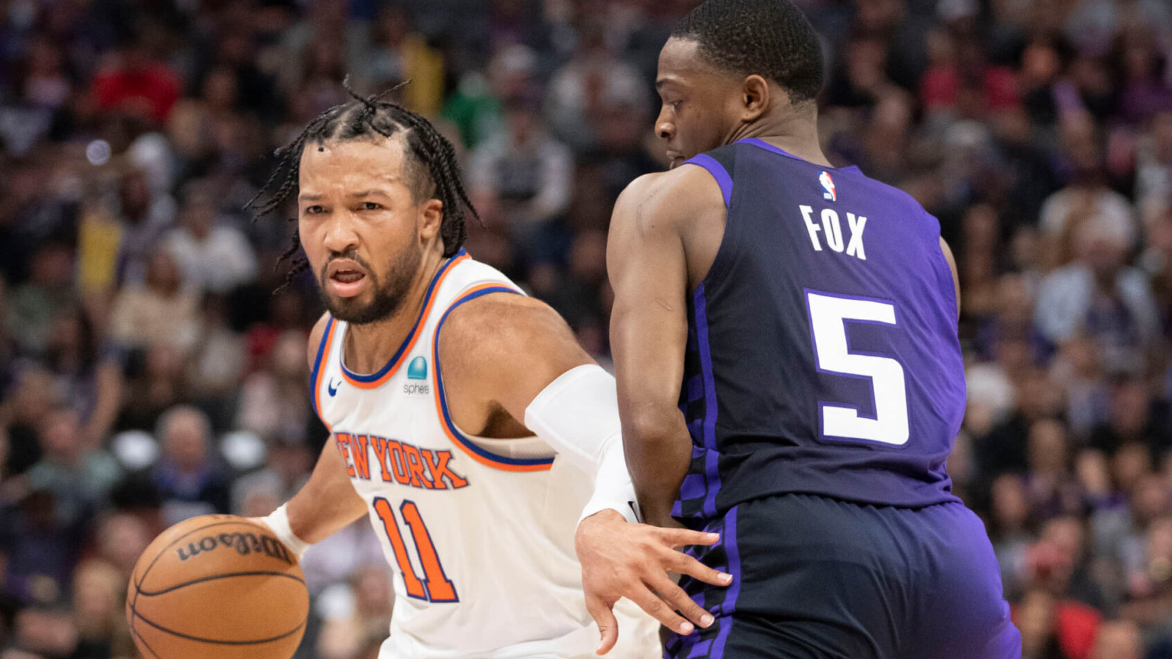 New York Knicks guard Jalen Brunson dribbles the basketball against Sacramento Kings guard De'Aaron Fox