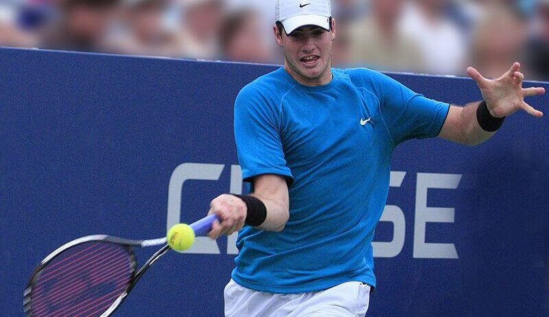 John Isner returning a ball.